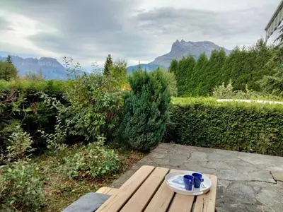 a living room with two blue couches and a tv at Studio Les cimes blanches by Interhome in Saint-Gervais-les-Bains