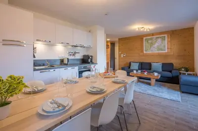 a kitchen and living room with a table and chairs at Apartment Arbois in Saint-Gervais-les-Bains