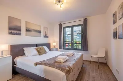 a bedroom with a large bed and a window at Apartment Arbois in Saint-Gervais-les-Bains