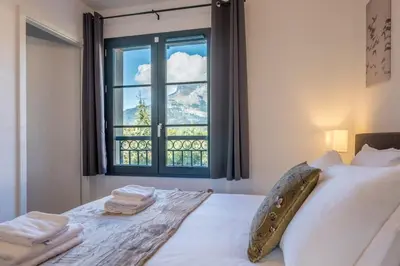 a bedroom with a bed with a large window at Apartment Arbois in Saint-Gervais-les-Bains
