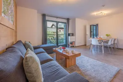 a living room with a blue couch and a table at Apartment Arbois in Saint-Gervais-les-Bains