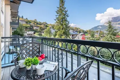 a table and chairs on a balcony with a view at Apartment Arbois in Saint-Gervais-les-Bains