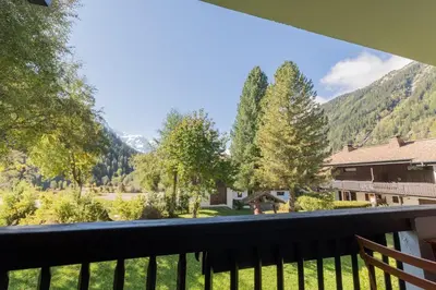 a view of the mountains from the balcony of a house at Appartement T4 familial à Chamonix, avec Parking et près des Grand Montets in Chamonix-Mont-Blanc