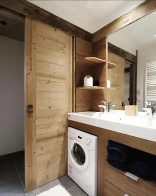 a bathroom with a sink and a washing machine at Logement de vacances exclusif - Plein centre in Arâches-la-Frasse