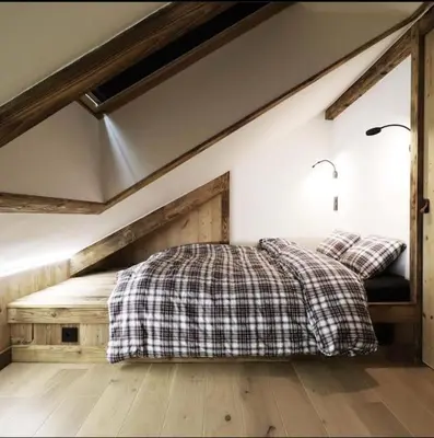 a bedroom with a bed with a plaid blanket at Logement de vacances exclusif - Plein centre in Arâches-la-Frasse