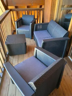 a balcony with two chairs and two tables and chairs at Logement de vacances exclusif - Plein centre in Arâches-la-Frasse