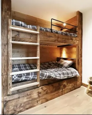 two bunk beds in a room with wooden walls at Logement de vacances exclusif - Plein centre in Arâches-la-Frasse