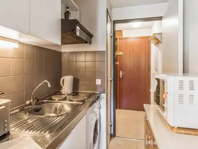 a small kitchen with a sink and a microwave at Bel appartement au pied des pistes-Megeve in Demi-Quartier
