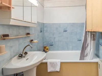 a bathroom with a sink and a bath tub at Bel appartement au pied des pistes-Megeve in Demi-Quartier