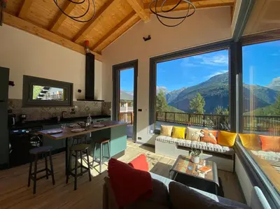 a kitchen and living room with a view of mountains at Mountain Cabin - vue montagne - 4 personnes in Les Houches