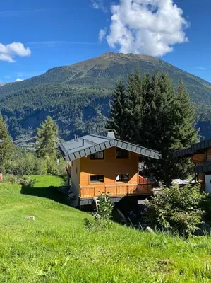 a house on a hill in front of a mountain at Mountain Cabin - vue montagne - 4 personnes in Les Houches