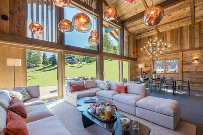 a living room with a couch and a table at Chalet Diane I Luxe I Proche des pistes in Combloux