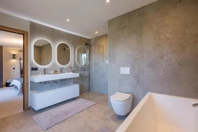 a bathroom with a tub and a sink and mirror at Chalet Diane I Luxe I Proche des pistes in Combloux