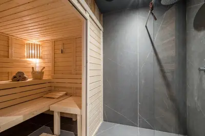 a sauna with a shower and a bench at Chalet Diane I Luxe I Proche des pistes in Combloux