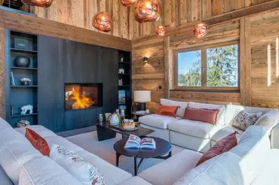 a living room with a couch and a fireplace at Chalet Diane I Luxe I Proche des pistes in Combloux