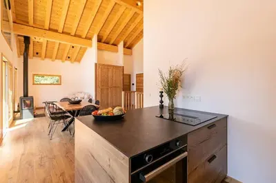 a kitchen with a black counter top in a room at L'Ecrin in Plateau dʼAssy