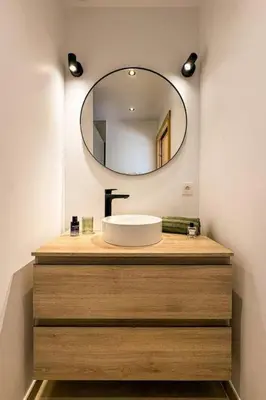 a bathroom with a sink and a mirror at L'Ecrin in Plateau dʼAssy