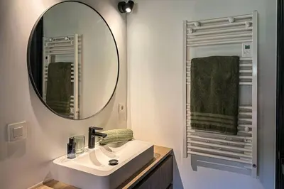 a bathroom with a sink and a mirror at L'Ecrin in Plateau dʼAssy