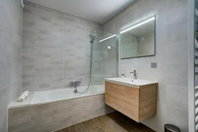 a bathroom with a tub and a sink and a shower at White Pearl - Centre de Chamonix - 2ch - Renove in Chamonix-Mont-Blanc