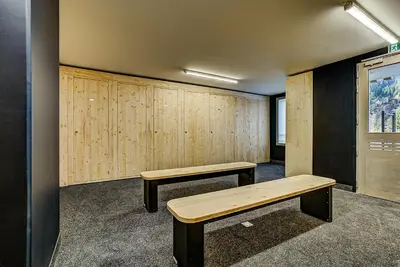 a locker room with two benches and a window at White Pearl - Centre de Chamonix - 2ch - Renove in Chamonix-Mont-Blanc