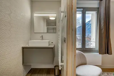 a bathroom with a sink and a mirror and a window at White Pearl - Centre de Chamonix - 2ch - Renove in Chamonix-Mont-Blanc