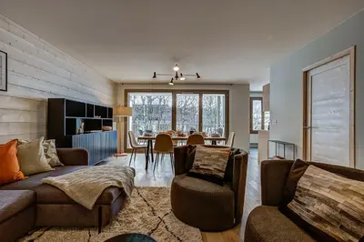 a living room with a couch and a table at White Pearl - Centre de Chamonix - 2ch - Renove in Chamonix-Mont-Blanc