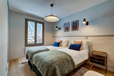 a bedroom with two beds and a window at White Pearl - Centre de Chamonix - 2ch - Renove in Chamonix-Mont-Blanc