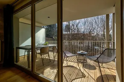 a screened in porch with a table and chairs at White Pearl - Centre de Chamonix - 2ch - Renove in Chamonix-Mont-Blanc