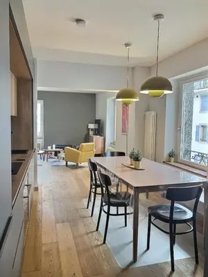 a kitchen and dining room with a table and chairs at Magnifique Appartement au Centre de Chamonix in Chamonix-Mont-Blanc