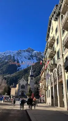 a snow covered road with mountains in the background at Magnifique Appartement au Centre de Chamonix in Chamonix-Mont-Blanc