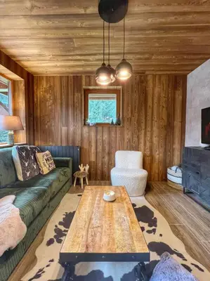 a living room with a couch and a coffee table at Megève appartement centre ville palais des sports in Megève