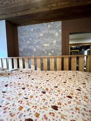 a bedroom with a large bed with a large window at Megève appartement centre ville palais des sports in Megève