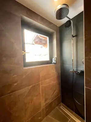 a bathroom with a shower and a window at Megève appartement centre ville palais des sports in Megève