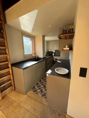 a small kitchen with a sink and a microwave at Duplex aux pieds des pistes à Rochebrune in Megève