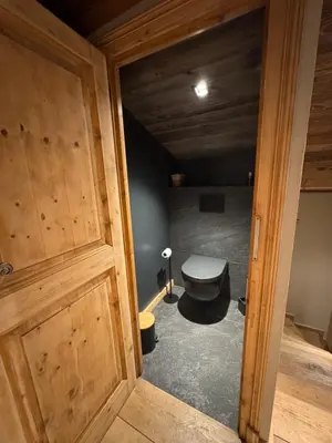 an empty room with wooden floors and a doorway at Duplex aux pieds des pistes à Rochebrune in Megève