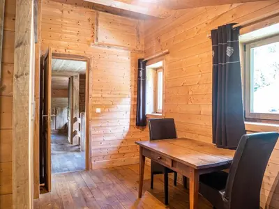 a wooden dining room with a wooden table and chairs at Demi-Chalet en plein coeur de Chamonix - Gabi in Chamonix-Mont-Blanc