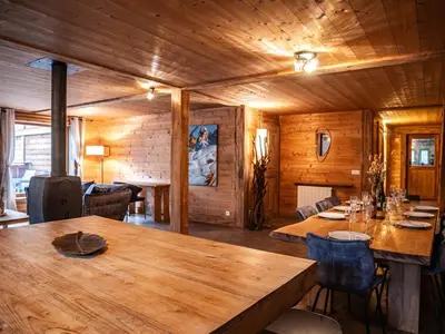 a dining room with a large wooden table and chairs at Demi-Chalet en plein coeur de Chamonix - Gabi in Chamonix-Mont-Blanc