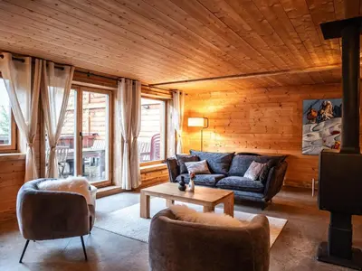 a living room with a couch and a table at Demi-Chalet en plein coeur de Chamonix - Gabi in Chamonix-Mont-Blanc