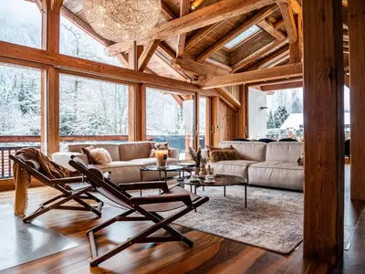 a living room with two chairs and a couch at Chalet Bonami 450 m2 salle cinema jacuzzi hammam in Chamonix-Mont-Blanc