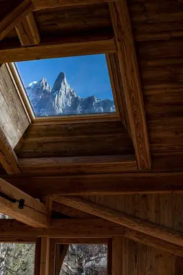 a window in the ceiling of a room with a mountain at Chalet Bonami 450 m2 salle cinema jacuzzi hammam in Chamonix-Mont-Blanc