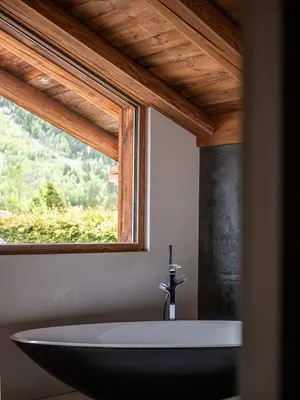 a bathroom with a bath tub and a window at Chalet Bonami 450 m2 salle cinema jacuzzi hammam in Chamonix-Mont-Blanc