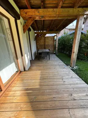 a wooden porch with a table on a house at Agora in Samoëns