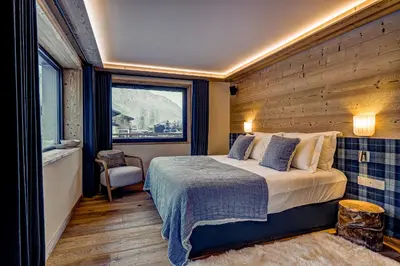 a hotel room with a bed and a window at Chalet Josephine, Chamonix Les Bois in Chamonix-Mont-Blanc