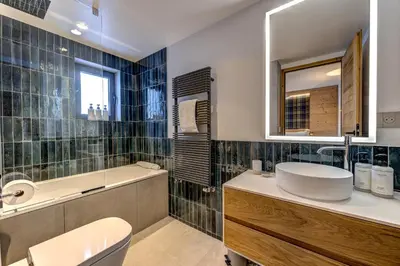 a bathroom with a sink toilet and a mirror at Chalet Josephine, Chamonix Les Bois in Chamonix-Mont-Blanc