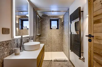 a bathroom with a sink and a shower at Chalet Josephine, Chamonix Les Bois in Chamonix-Mont-Blanc