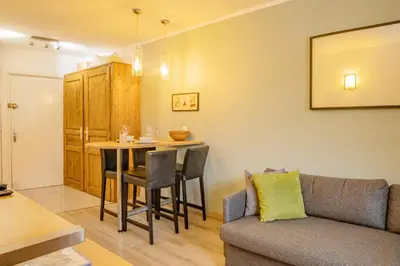 a living room with a couch and a table at Apartment Lognan 1 - A Chamonix Mont Blanc Haven in Chamonix-Mont-Blanc