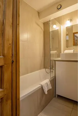 a bathroom with a tub and a sink at Apartment Lognan 1 - A Chamonix Mont Blanc Haven in Chamonix-Mont-Blanc