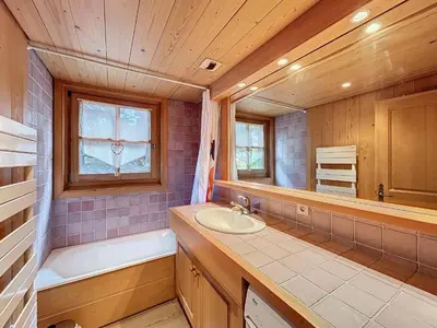 a bathroom with a sink and a bath tub and a window at Confortable 2 pièces avec jardin, parking, face au Mont Blanc - FR-1-560-152 in Combloux