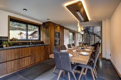 a dining room with a long wooden table and chairs at Chalet Cotes du Lavancher in Chamonix-Mont-Blanc