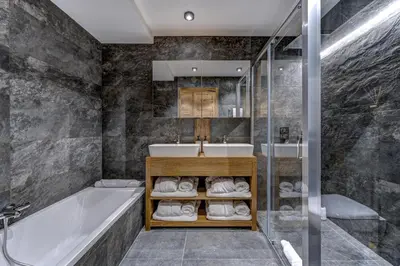a bathroom with a tub and a sink at Chalet Cotes du Lavancher in Chamonix-Mont-Blanc